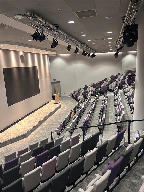 The auditorium at 51 Lime Street, with raked seating and a presentation screen.